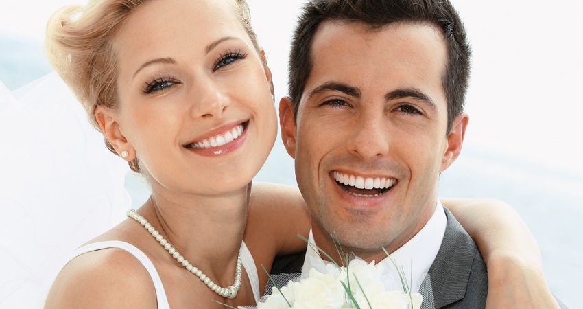 A newlywed couple smiling together