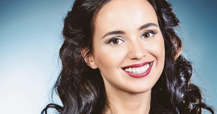 Woman with braces smiles